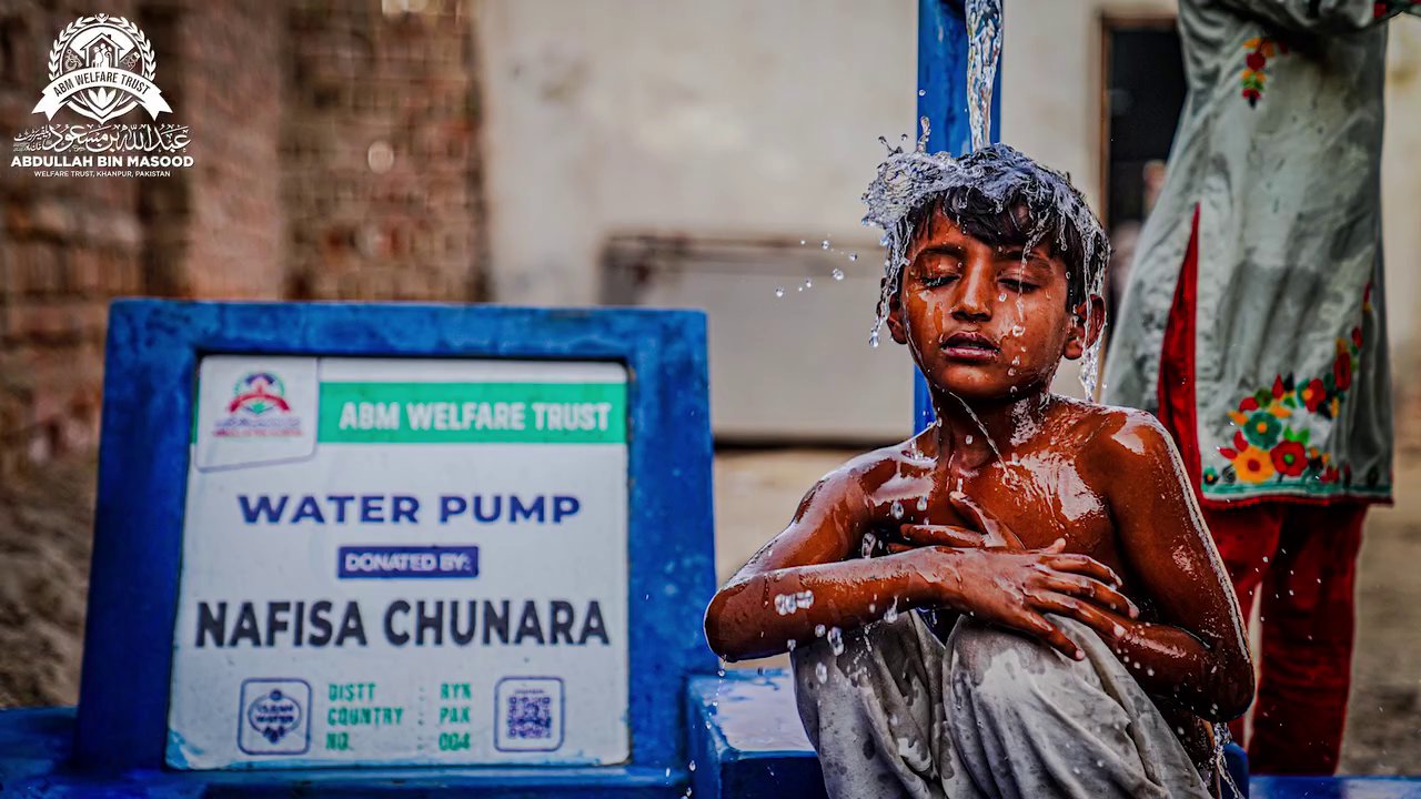 Child bathing at clean water hand pump
