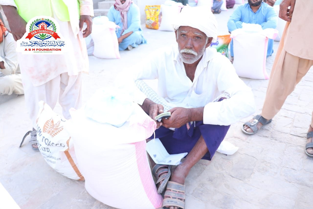 Elderly man receiving flood relief food ration