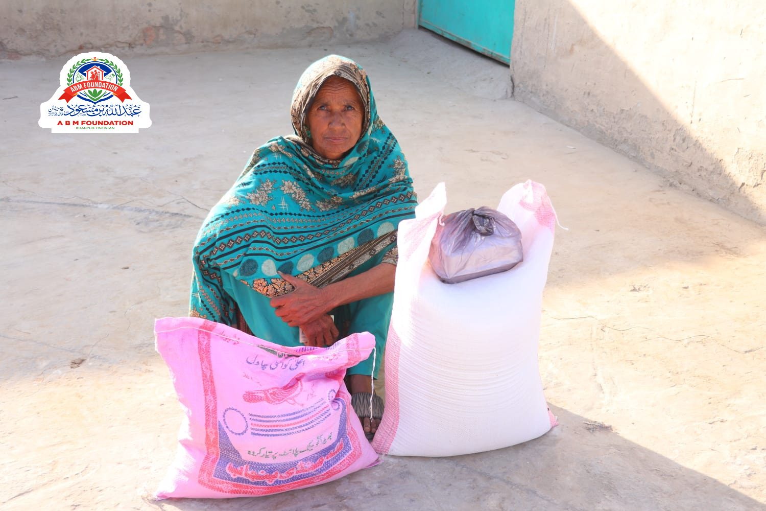 Elderly woman receiving flood relief food ration
