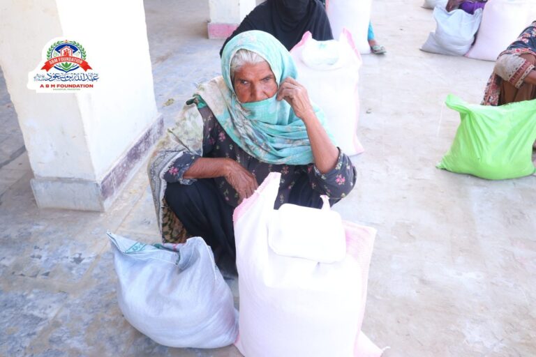 Elderly woman with flood relief ration supplies