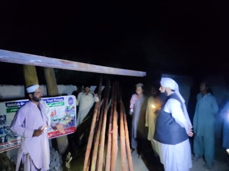 Flood relief truck delivering rolled carpets at night