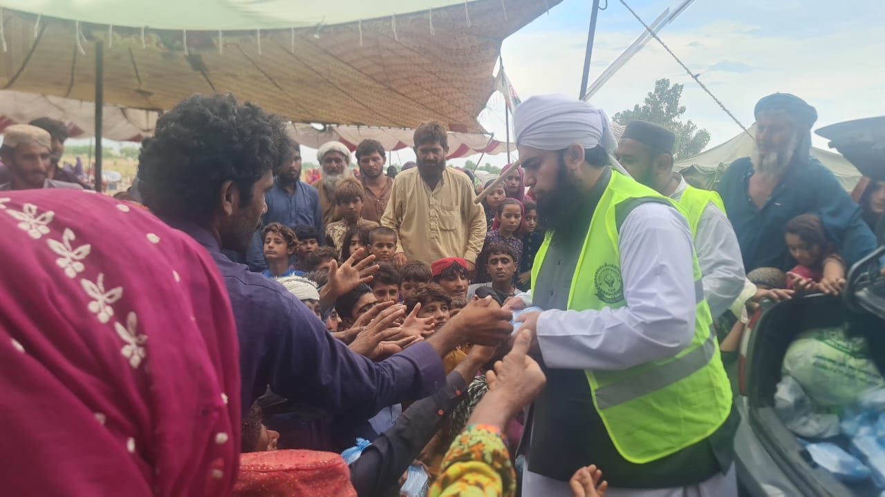 Flood relief volunteer distributing cash assistance
