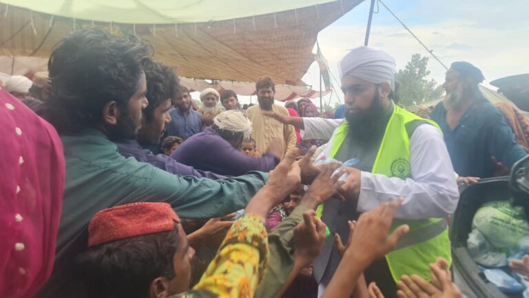 Flood relief volunteer distributing cash to families