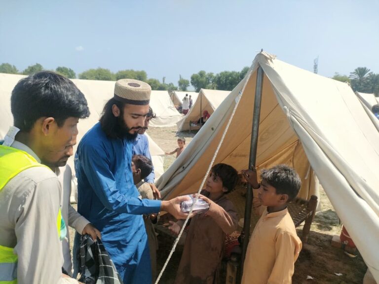 Flood relief volunteer giving cooked meal to child