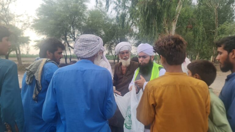 Flood relief volunteer speaking with affected families
