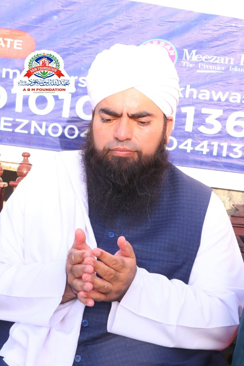 Religious scholar making dua during ration distribution