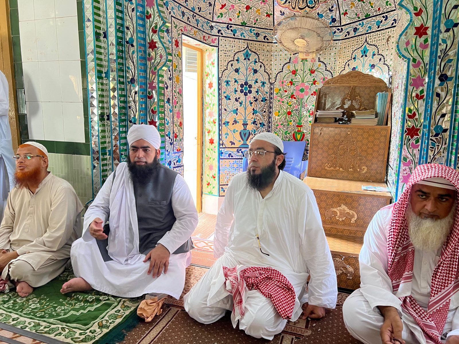 Religious scholars seated inside mosque