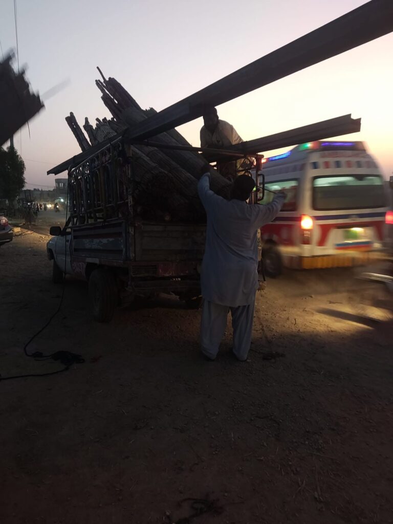 Truck loaded with rolled carpets and relief supplies