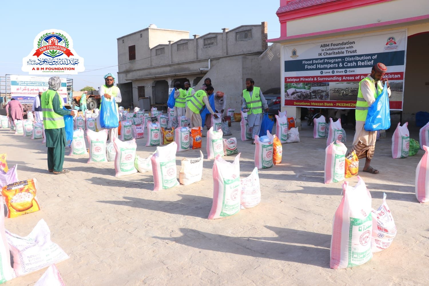 Volunteers arranging flood relief food ration bags