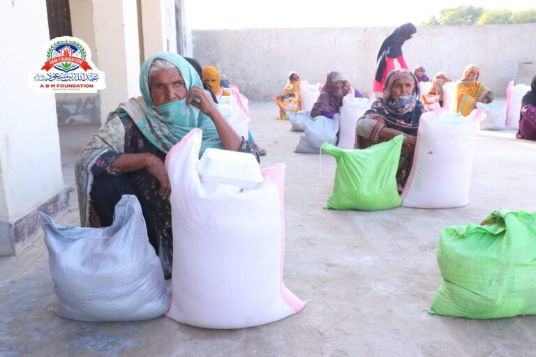 Women receiving flood relief food ration packages